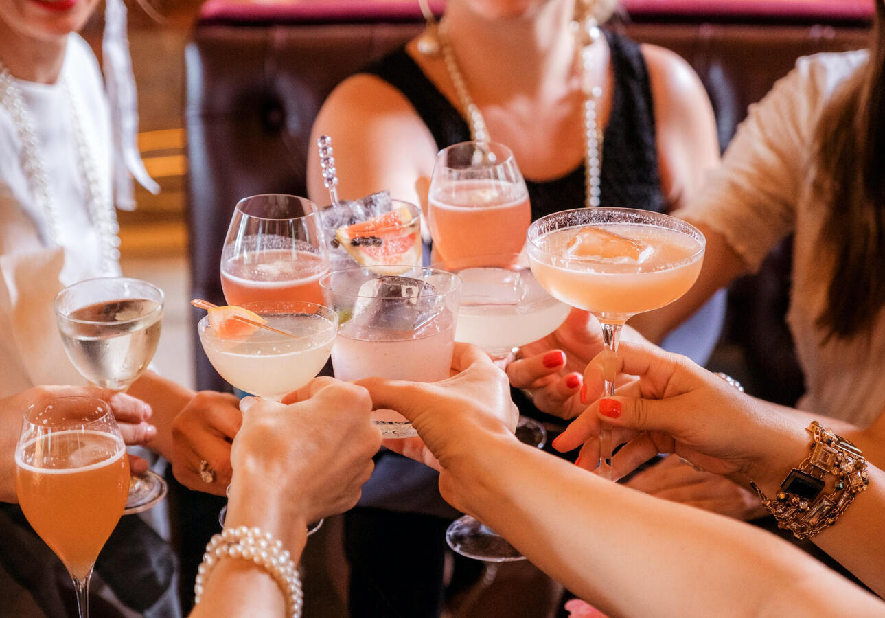 A group of people clinking cocktail glasses